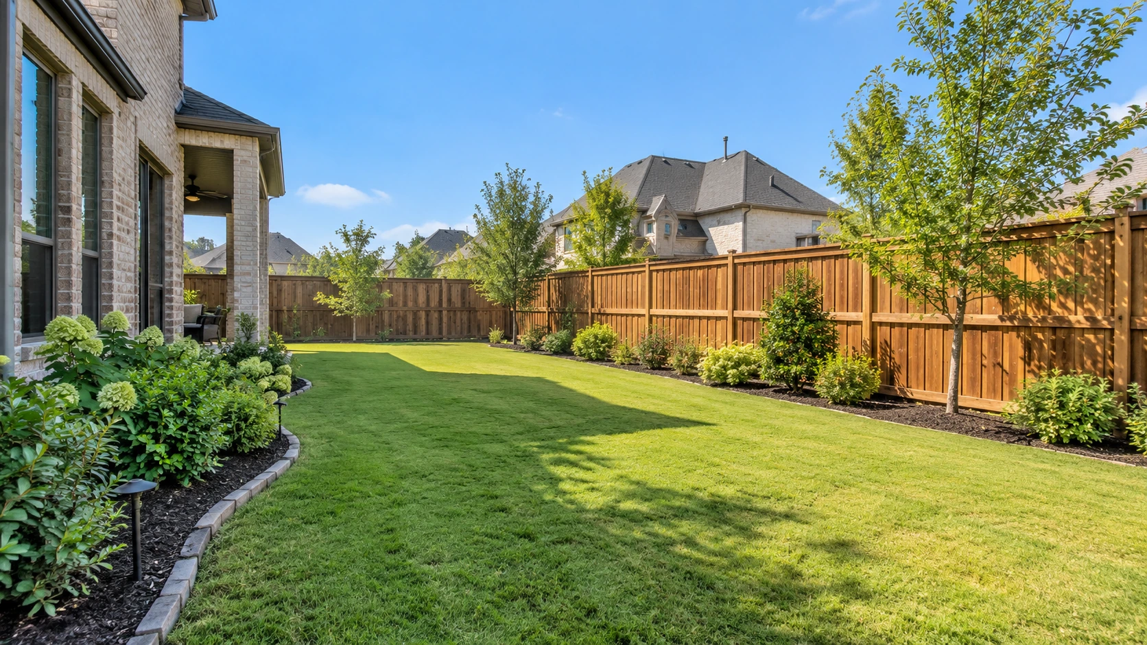 Completed residential wood fence enclosing a Frisco backyard